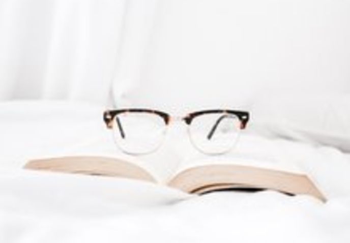 glasses sitting on top of book