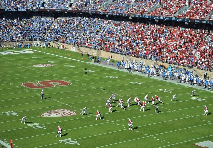 Wide-angle view of a Stanford Cardinal football game at Stanford Stadium with fans in the stands