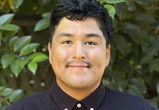 Headshot of Acevedo with greenery in background