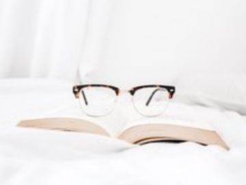 glasses sitting on top of book