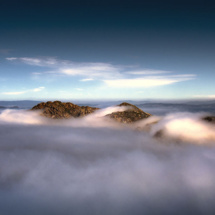 mountain tops amidst clouds